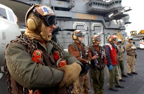 US Navy 021114-N-3236B-033 F-A-18C Hornet plane captains assigned to Carrier Air Wing Five (CVW 5) try to keep warm during flight operations during Exercise Keen Sword 2003