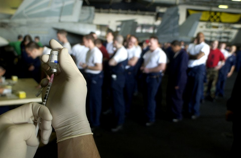 US Navy 030106-N-4142G-005 A syringe is filled with Bacillusanthracis as crewmembers wait their turn in line to receive the shot