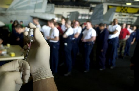 US Navy 030106-N-4142G-005 A syringe is filled with Bacillusanthracis as crewmembers wait their turn in line to receive the shot