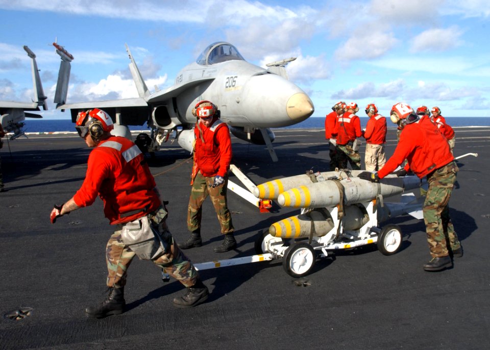 US Navy 030116-N-6895M-509 Aviation Ordnancemen assigned to the Hunters load bombs under the wing of a F-A-18