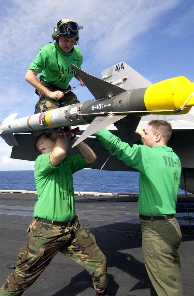 US Navy 021129-N-4142G-036 securing screws on the wing on an F-A-18