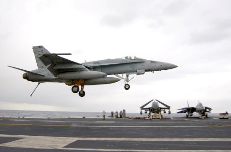 US Navy 030124-N-1810F-010 Hornet with its tailhook down, attempts a controlled landing on the ship's flight deck
