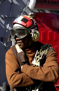 US Navy 020916-N-0413R-007 Sailor prepares to secure a SH-60 helicopter