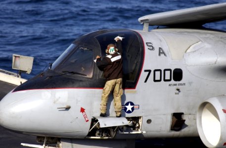 US Navy 021114-N-2326B-007 plane captain assigned to the Red Tails of Sea Control Squadron Two One (VS-21) prepares an S-3B Viking for the next launch on the ship's flight schedule