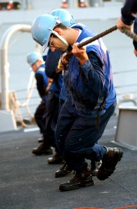US Navy 021108-N-5471P-040 Sailors heave on the messenger line to prepare for an early morning replenishment at sea