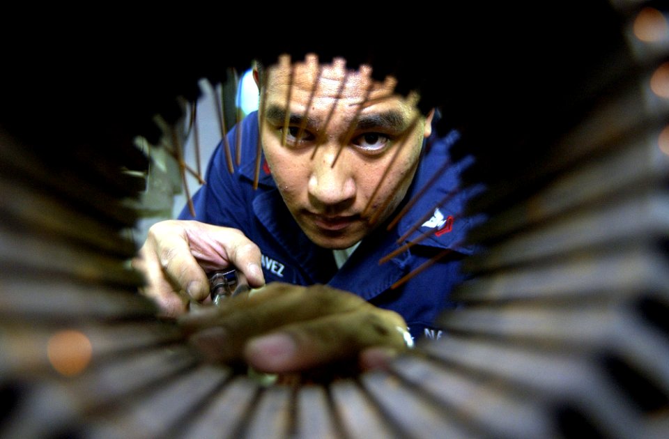 US Navy 021210-N-4142G-144 preparing the stator of a motor for rewinding