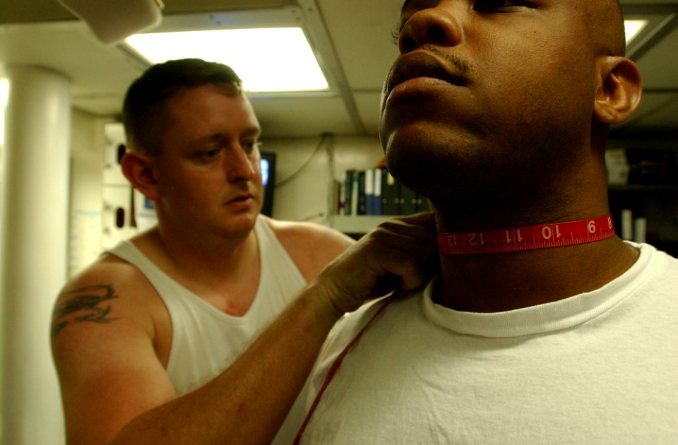 US Navy 021022-N-4309A-113 Chief Engineman Gureau measures sailors in order to determine whether or not sailors they meet body fat requirements in preparation for the Navy's semi-annual Physical Readiness Test (PRT)