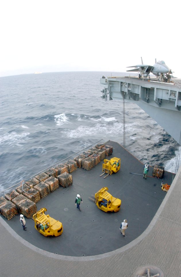 US Navy 021116-N-1810F-020 Supplies are loaded on to one of four aircraft elevators during a replenishment at sea