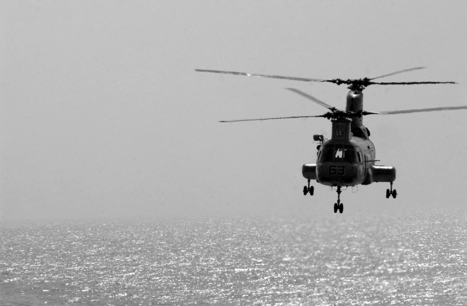 US Navy 021023-N-5471P-004 A CH-46 Sea Knight helicopter carries supplies to the Mobile Bay during a replenishment at sea (RAS) with the USS Camden (AOE 2)