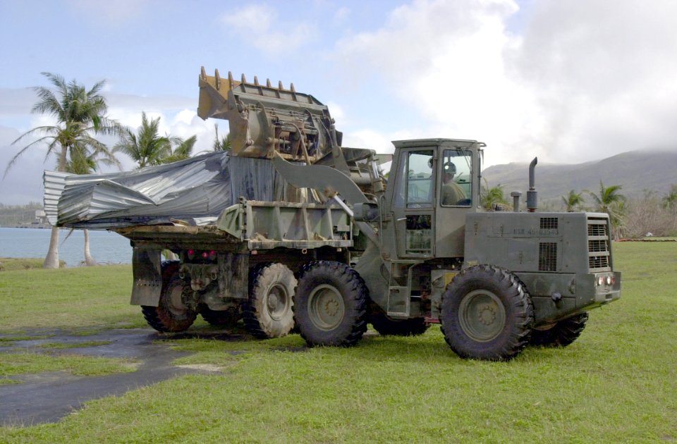 US Navy 021216-N-7293M-014 Builder 2nd Class Chad Johnson loads debris onto a dump truck during recovery efforts from damages incurred at U.S. Naval Forces Marianas from the effects of Super Typhoon Pongsona