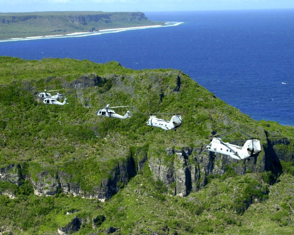 US Navy 030116-F-3488S-058 Two UH-46 Sea Knights and three UH-60 Black Hawks fly over the northern tip of Guam as part of a six-helicopter formation during flight training