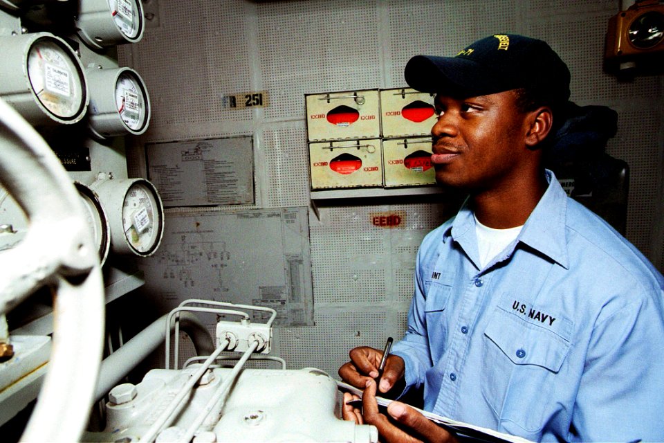 US Navy 030108-N-5786V-002 Fireman Herschel Swint from Savannah, Ga., records the hydraulic fluid pressure in the ship's aft steering units aboard USS Theodore Roosevelt (CVN 71)
