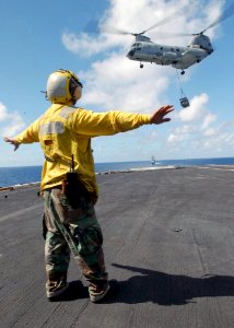 US Navy 030122-N-6895M-508 Aviation Boatswain's Mate directs a CH-46