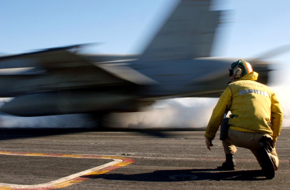US Navy 030125-N-1810F-004 F-A-18C launching from the ship's flight deck on one of four steam driven catapults
