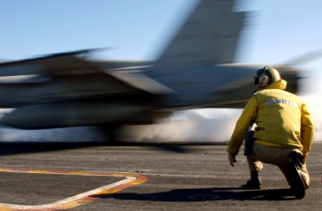 US Navy 030125-N-1810F-004 F-A-18C launching from the ship's flight deck on one of four steam driven catapults