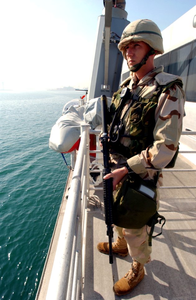 US Navy 030126-N-5319A-010 Staff Sgt. Marcus Gandee stands guard with an M-16 machine gun
