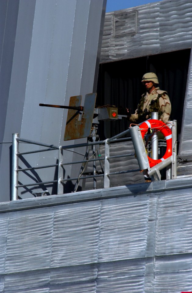 US Navy 030115-N-5319A-005 A soldier stands watch with a .50 caliber machine gun