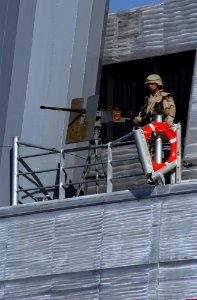 US Navy 030115-N-5319A-005 A soldier stands watch with a .50 caliber machine gun photo