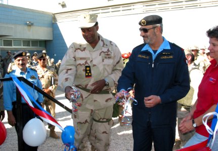 US Navy 030303-N-1050K-029 cut the ribbon for the grand opening of the Camp Patriot Army and Air Force Exchange Service (AAFES) store