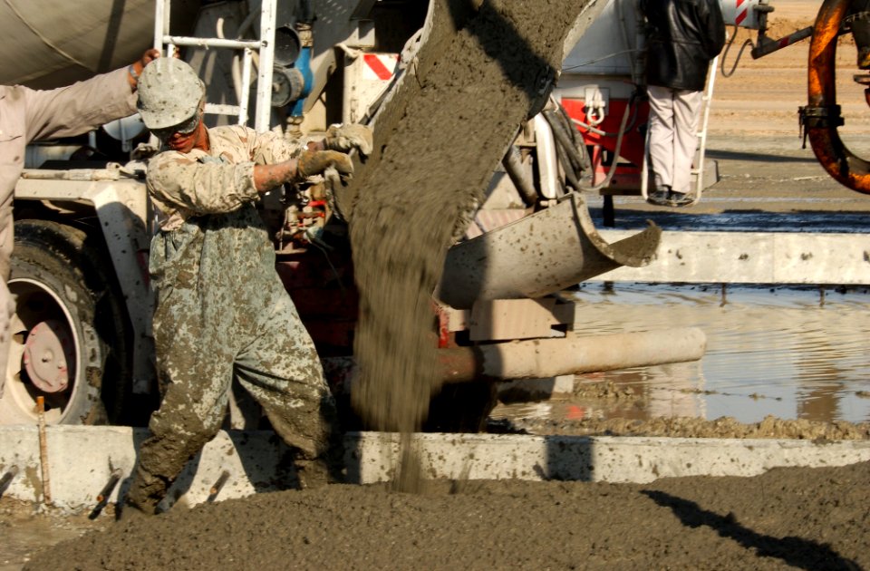 US Navy 030104-N-5319A-012 Seabees attached to Naval Mobile Construction Battalion Seventy-Four (NMCB-74) pour concrete for a C-130 aircraft staging area