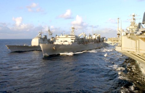 US Navy 030122-N-6895M-501 USS Anzio (CG 68) conducts an underway replenishment (UNREP) at sea off the starboard side of the Military Sealift Command oiler USNS Arctic (T-AOE 8), while Theodore Roosevelt conducts a simultaneous