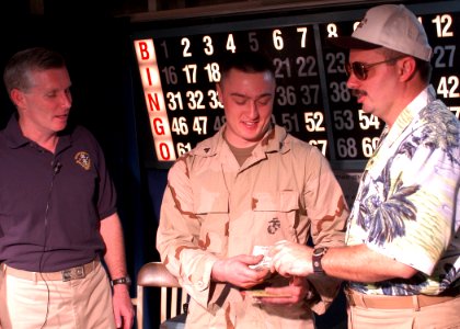 US Navy 030209-N-2972R-098 CO, CMC of USS Kearsarge (LHD 3) present over 2,000 dollars in prize money to winner of bingo tournament