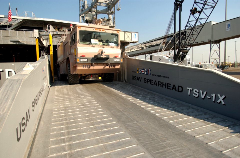 US Navy 030126-N-5319A-009 United States Army Vessel (USAV) Theater Support Vessel Spearhead (TSV-1X) off-loads an Army fire-fighting vehicle while pier-side at a port within the Central Command AOR
