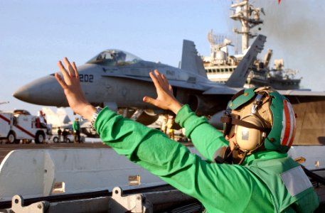 US Navy 021114-N-1810F-022 Aviation Boatswain's Mate 2nd Class Daniel Gadea from San Francisco, Calif., signals ready shoot before pushing the launch catapult button