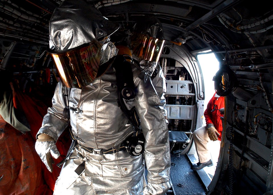 US Navy 030211-N-4048T-055 Sailors assigned to the Crash and Salvage Team aboard Kearsarge check a CH-46 Sea Knight helicopter on the flight deck during a fire drill