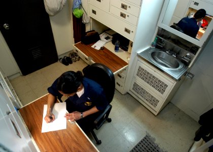US Navy 030208-N-4048T-153 Lt.j.g. Karen Sankes takes time to write a letter in her stateroom