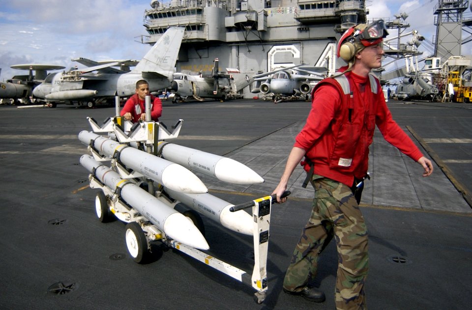 US Navy 021129-N-4142G-108 pulling a skid of (AIM-120) missiles to an F-A-18