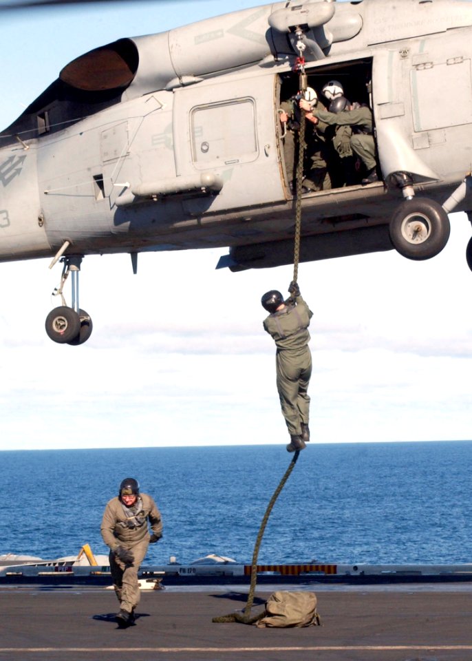 US Navy 030210-N-1328C-503 EOD team practice fast roping on the ship's flight deck from an SH-60F