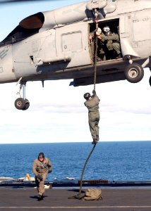 US Navy 030210-N-1328C-503 EOD team practice fast roping on the ship's flight deck from an SH-60F
