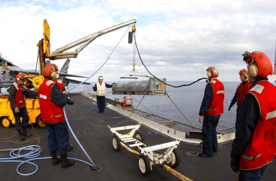 US Navy 030126-N-1810F-004 Aviation Ordnancemen lift an AIM-7