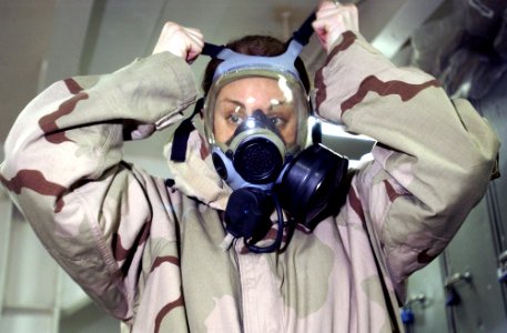 US Navy 030218-N-6141B-001 Damage Controlman 3rd Class Rosanna Colp from Lakesport, Calif., practices donning her Advanced Chemical Protective Gear (ACPG)