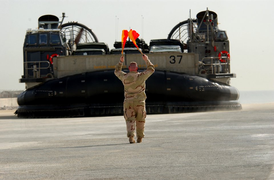 US Navy 030215-N-5319A-002 Chief Information Systems Technician Robert McBride directs a Landing Craft Air Cushioned (LCAC)