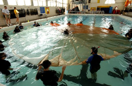 US Navy 031113-N-5862D-061 Students at the Aviation Rescue Swimmer School prepare to undergo a parachute disentanglement exercise