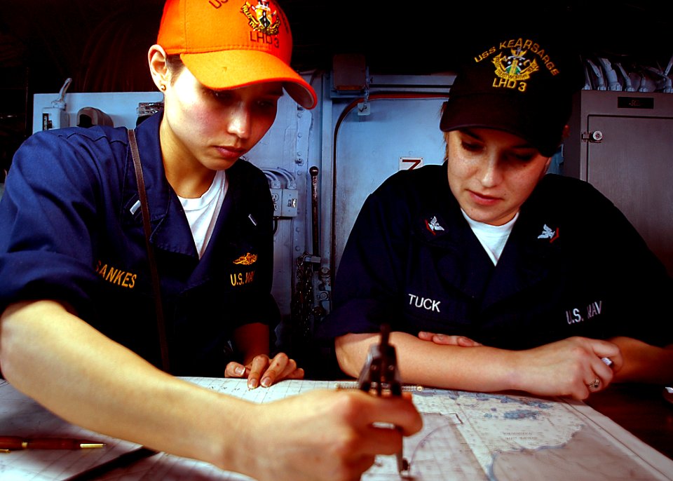 US Navy 030208-N-4048T-093 U.S. Navy Lt. j.g. Karen Sankes and Quartermaster 3rd Class Dawn Tuck plot a course while on bridge watch