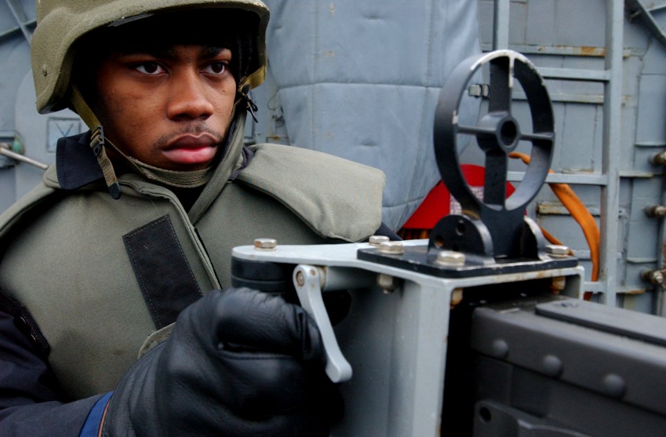 US Navy 030225-N-6141B-001 Ship's Serviceman Seaman Desmond Johnson stands lookout watch as part of the ship's self-defense force