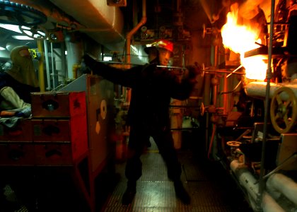 US Navy 030209-N-1512S-057 Fireman Apprentice lights the ^1 boiler in the Forward Main Machinery Room (FWD MMR)