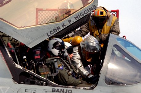 US Navy 030225-N-3235P-504 Members from Crash and Salvage division work to extract pilots from a simulated burning aircraft during flight drills on the ship