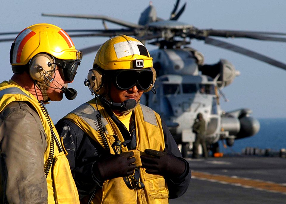 US Navy 030301-N-1512S-055 Aviation Boatswain's Mate 3rd Class Kelvin Bunchon (right) discusses upcoming flight operations with Senior Chief Aviation Boatswain's Mate Joseph Prejsnar