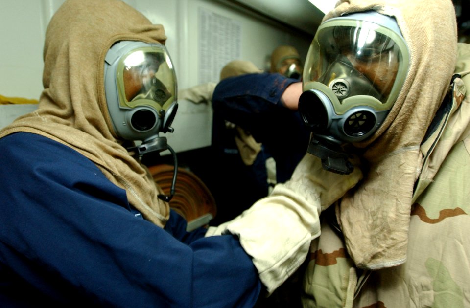 US Navy 030227-N-6141B-002 Crewmembers aboard the guided missile cruiser USS Anzio (CG 68) practice using their MCU-2P gas masks during a chemical, biological, and radiological training