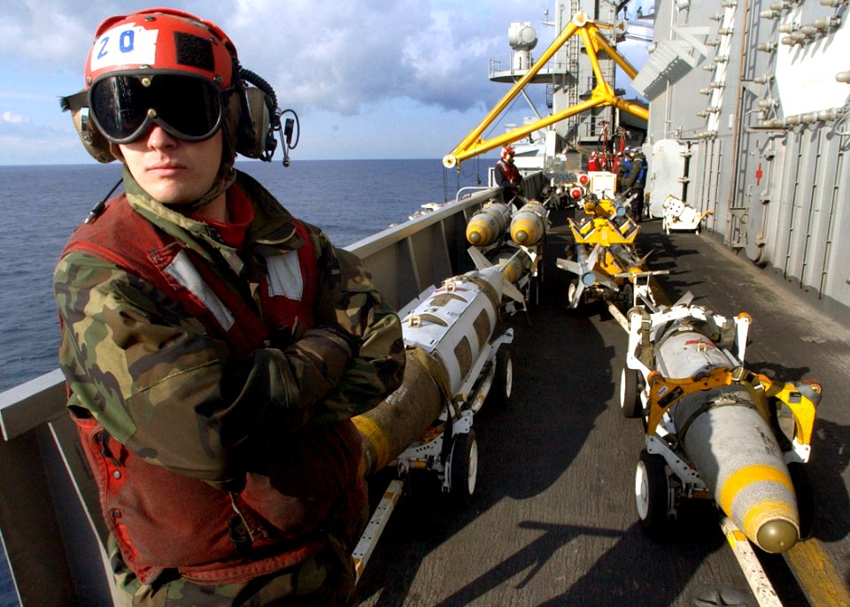 US Navy 030225-N-3235P-505 Lance Corporal Terry J. Depiero assigned to the Silver Eagles of Marine Fighter-Attack Squadron One One Five (VMFA-115), stands by in the bomb farm on the ship's flight deck