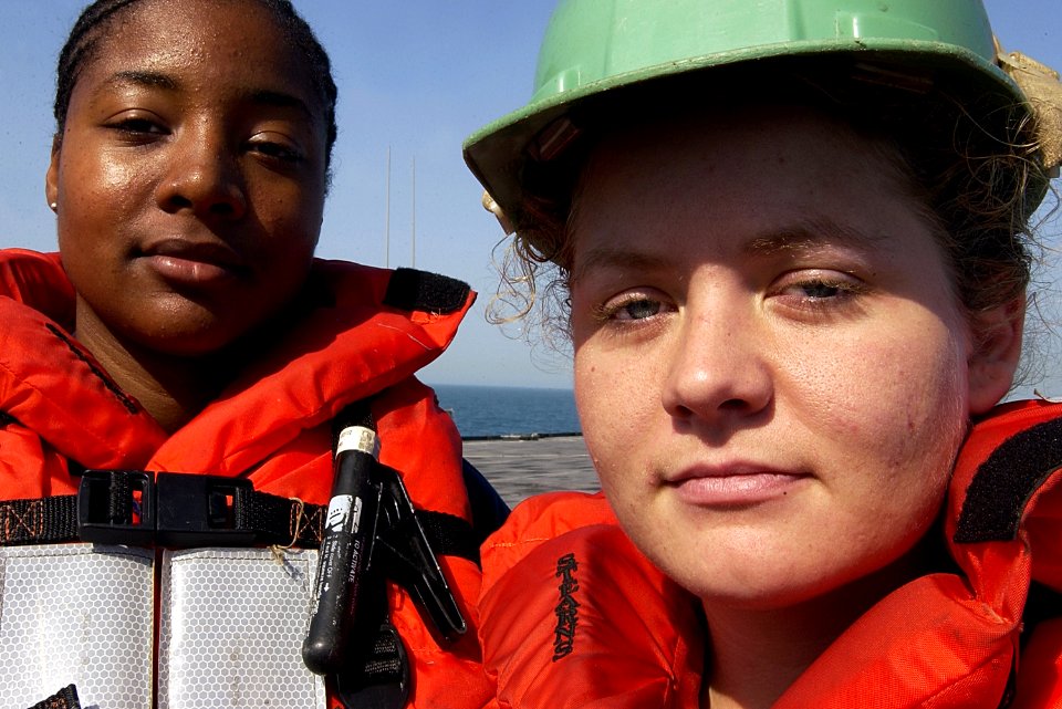 US Navy 030305-C-9409S-007 Seaman Charmeka Breckenridge and Seaman Nicole Hays, assigned to the amphibious transport dock USS Comstock (LSD 45), take a break from work while underway in the North Arabian Gulf