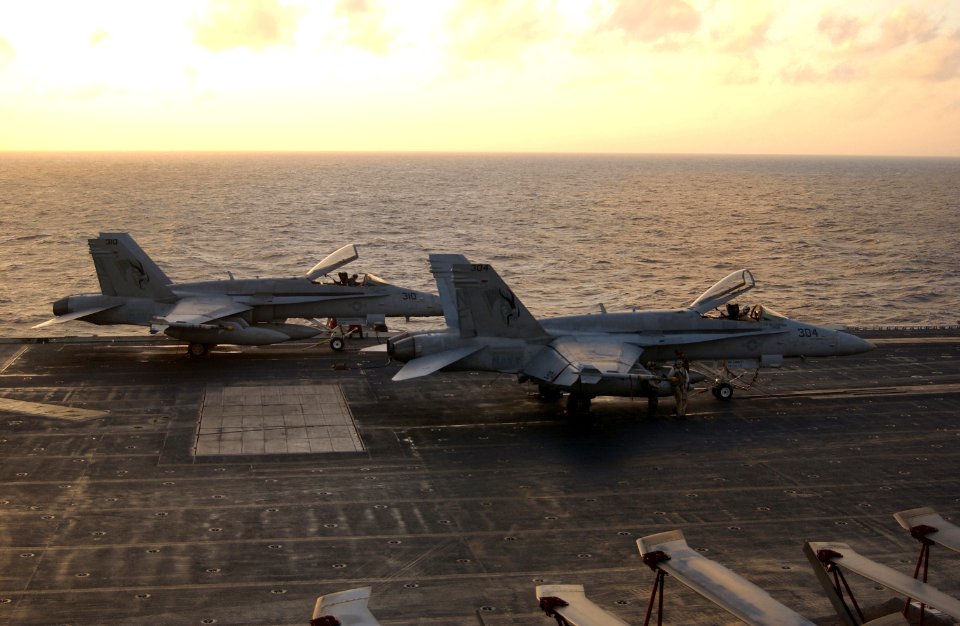 US Navy 030214-N-1810F-006 Two F-A-18C Hornets assigned to the Golden Dragons of Strike Fighter Squadron One Nine Two (VFA-192) sit prepared for a quick launch if necessary