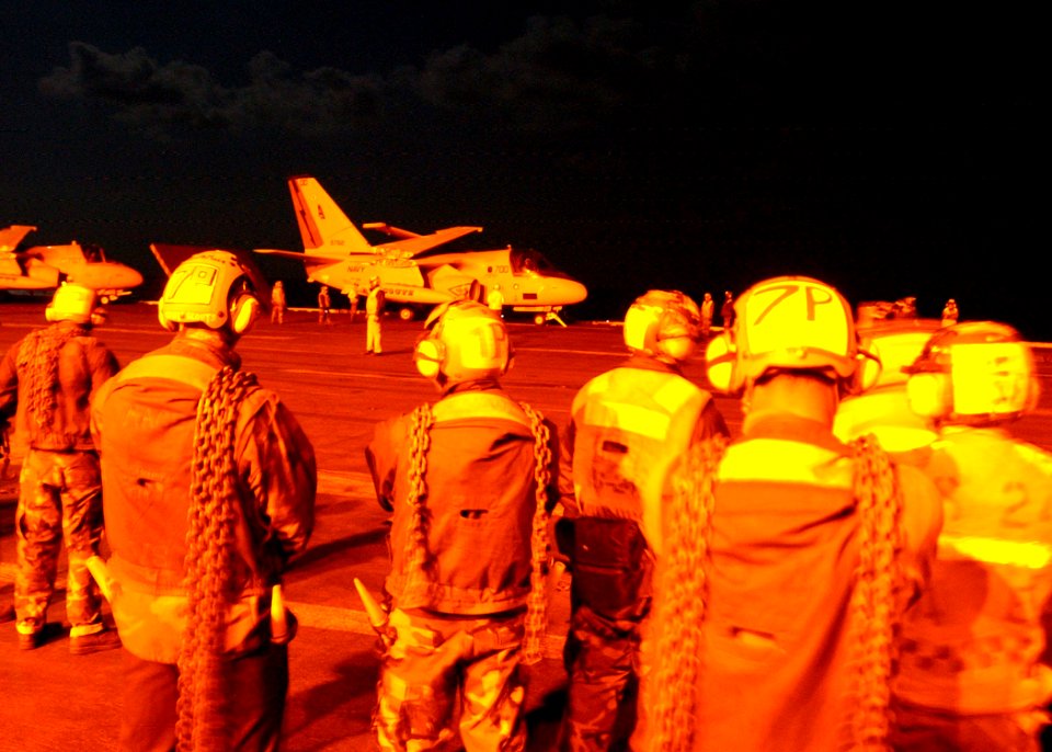 US Navy 030321-N-6895M-505 Flight deck personnel stand at the ready while an S-3B Viking assigned to the
