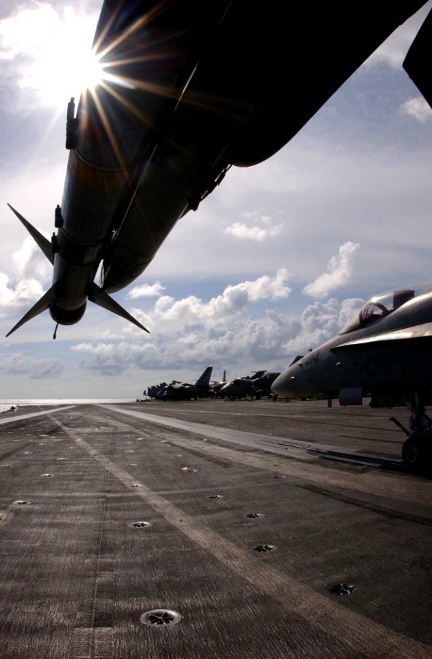 US Navy 030217-N-1810F-006 An F-A-18C Hornet loaded with the AIM-9M Sidewinder missile rests on the flight deck off USS Kitty Hawk (CV 63)