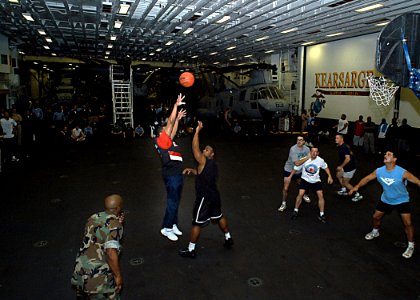 US Navy 030311-N-4048T-020 Sailors and Marines participate in a 3 on 3 basketball tournament in the hangar bay aboard the amphibious assault ship USS Kearsarge (LHD 3) photo