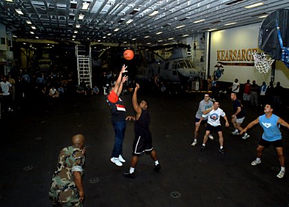 US Navy 030311-N-4048T-020 Sailors and Marines participate in a 3 on 3 basketball tournament in the hangar bay aboard the amphibious assault ship USS Kearsarge (LHD 3)